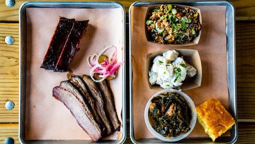 A two-meat plate of St. Louis-style pork ribs and beef brisket with three sides and cornbread.. The two-meat plate typically includes two sides. CONTRIBUTED BY HENRI HOLLIS