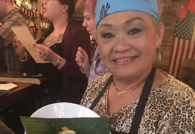 Betty Hsu holds her Malaysian Yellow Curry Chicken at the Chinese New Year party at Sweet Auburn BBQ in February.