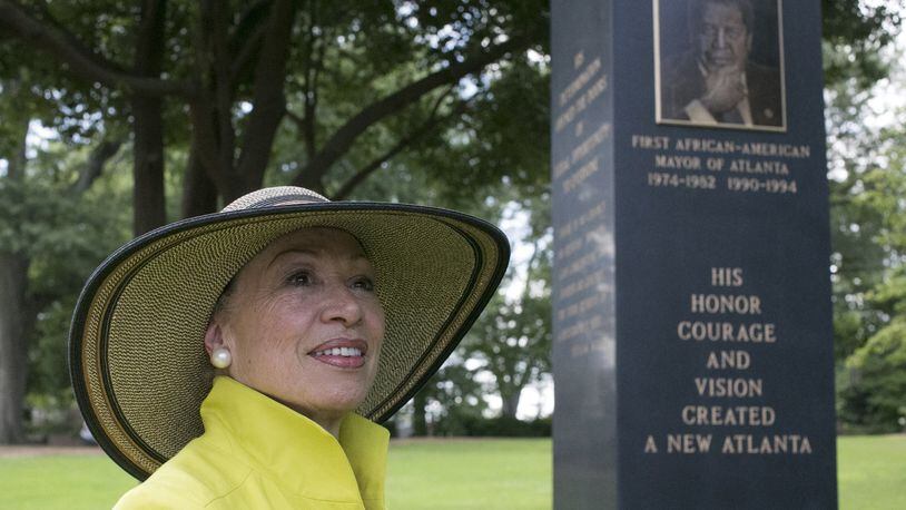 Valerie Jackson, the widow of Maynard Jackson, looks toward the Atlanta skyline, which the portrait of Maynard is facing, as she visited the 14.5-foot monument she erected on her husband’s gravesite at Oakland cemetery. BOB ANDRES /BANDRES@AJC.COM