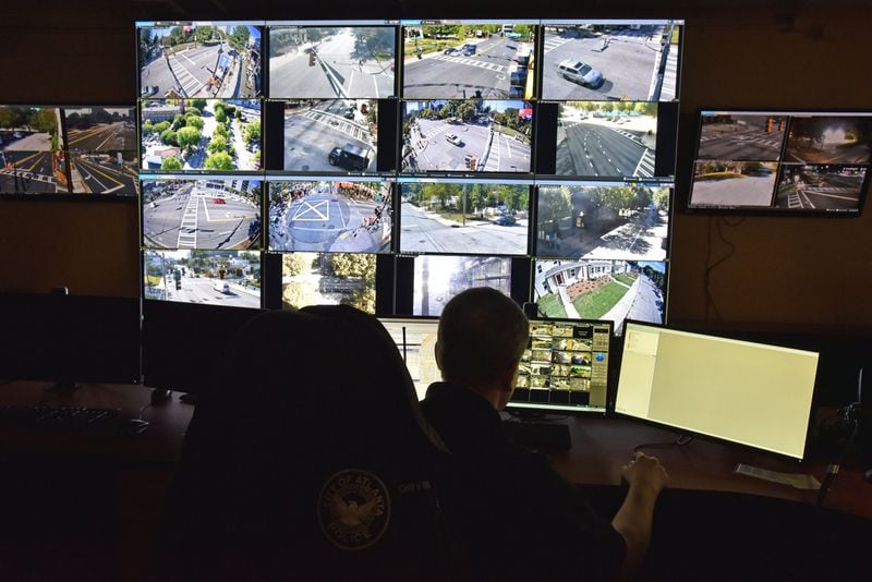 Atlanta police monitor surveillance cameras for crime. A new network of more than 4,500 surveillance cameras from across the city will allow officers to pull up footage on their cellphones and laptops from inside their squad cars, before they even get to a scene. (Hyosub Shin / Hyosub.Shin@ajc.com)