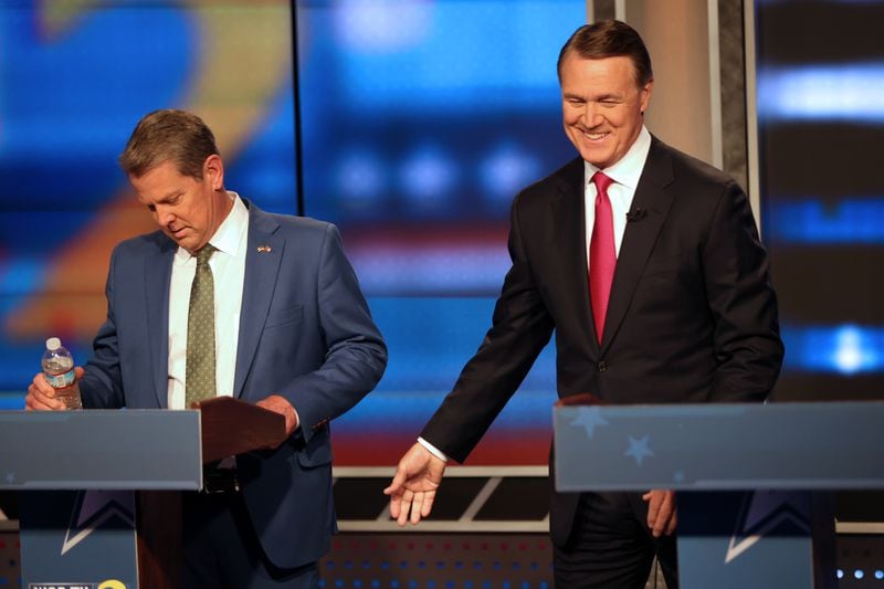 Gov. Brian Kemp, left, and former U.S. Sen. David Perdue debate ahead of the GOP primary in May. Kemp came out of the primary strengthened by a huge victory over Perdue, who had the backing of former President Donald Trump. The governor has held a statistically significant lead over Democrat Stacey Abrams in almost every recent public poll. Miguel Martinez /miguel.martinezjimenez@ajc.com