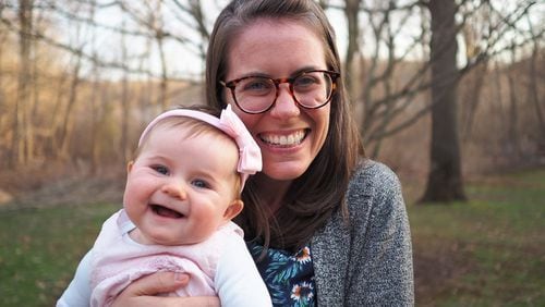 Nichole Mitchell, a nurse practitioner, holds her daughter, June. Mitchell says a residency program helped her develop a specialty in caring for patients with HIV and hepatitis C, as well as transgender care. (Courtesy of Nichole Mitchell)