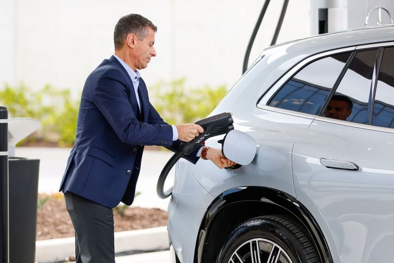  Dimitris Psillakis, President & CEO of Mercedes-Benz USA, is seen plugging the electric charger into a car during the unveiling of the first-of-its-kind EV fast-charging hub at the company’s U.S. headquarters, kicking off an effort to install 2,000 charges worldwide by the end of 2024.
Miguel Martinez /miguel.martinezjimenez@ajc.com