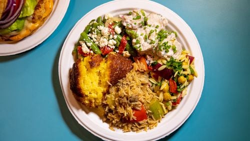 Nani’s Piri Piri Chicken Sides including Confit Potato Salad, Green Bean Salad, Savory Corn Pudding, Dirty Rice, and Mediterranean Orzo Salad.  (Mia Yakel for The Atlanta Journal-Constitution)