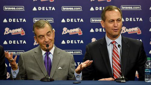 Former Braves president John Schuerholz reacts to comments by Derek Schiller (right), new Braves president of business, about his suit suggesting he was already dressing the part of vice chairman.
