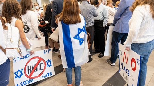 210923-Marietta-Claudia Rolam, wrapped in the Israeli flag,  protests outside of the Cobb County School Board meeting Thursday evening, Sept. 23, 2021, after anti-semitic vandalism was discovered at two Cobb County High Schools. Rolam is a member of Temple Emanuel in Atlanta. Ben Gray for the Atlanta Journal-Constitution