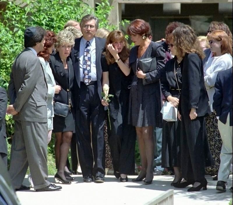 FILE - Fred Goldman, left center, is flanked by his wife, Patti, left, and daughter Kim, center, as they leave the Valley Oaks Memorial Park in Westlake Village, Calif., Thursday, June 16,1994, after attending the funeral services for their son, Ronald Goldman, who was killed at Nicole Brown Simpson's Los Angeles-area condominium oOn June 12, 1994. O.J. Simpson, the decorated football superstar and Hollywood actor who was acquitted of charges he killed his former wife and her friend but later found liable in a separate civil trial, has died. He was 76. (AP Photo/Kevork Djansezian, File)
