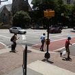 Pedestrians walk on Peachtree on Wednesday, July 12, 2023 in Atlanta. (Michael Blackshire/Michael.blackshire@ajc.com)