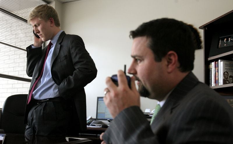 Nick Ayers, left, and Derrick Dickey are shown working in May 2006 in Gov. Sonny Perdue's campaign headquarters. Dickey later went on to lead David Perdue's campaign for the U.S. Senate and then served as his chief of staff. But he's now working with an outside group that is backing Gov. Brian Kemp over David Perdue in the May 24 GOP primary. Ayers is believed to be siding with David Perdue. (LOUIE FAVORITE/AJC staff)