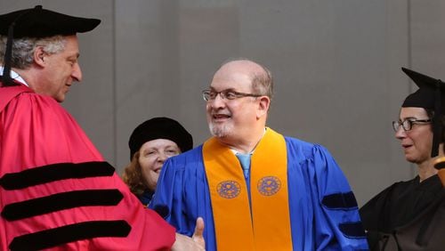Salman Rushdie is congratulated as he receives an honorary Doctor of Letters degree. Author and human rights advocate Sir Salman Rushdie, a University Distinguished Professor at Emory, delivered the keynote address at Emory University's 170th commencement Monday Morning. More than 4,500 graduates took part, about half earning bachelor's degrees from Emory College of Arts and Sciences and half representing Emory's graduate and professional schools. BOB ANDRES / BANDRES@AJC.COM