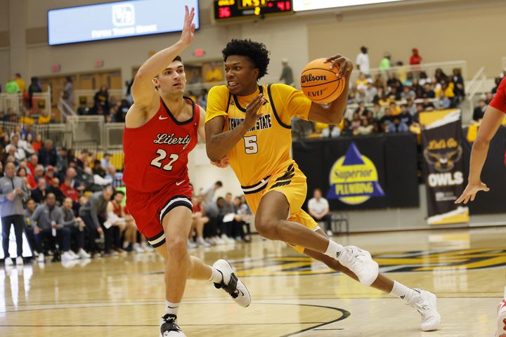 Kennesaw State forward Brandon Stroud (5) dribbles against Liberty Flames forward Kyle Rode (22) in the first half at the Kennesaw State Convention Center on Thursday, Feb 16, 2023.
 Miguel Martinez / miguel.martinezjimenez@ajc.com