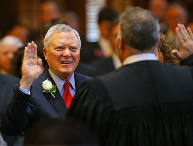 Hall County Superior Court Judge Jason Deal (right) swears in his father, Gov. Nathan Deal, for his second term of office on Jan. 12, 2015. (Curtis Compton/ccompton@ajc.com)