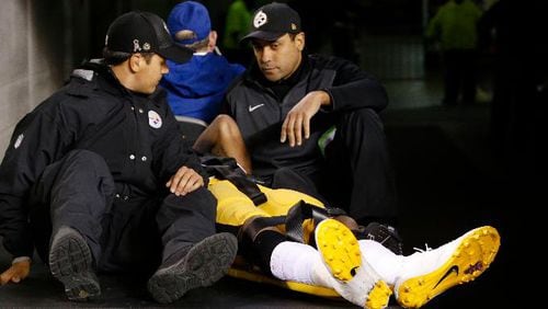 Pittsburgh Steelers inside linebacker Ryan Shazier, in yellow, is carted off the field after an injury in the first half of an NFL football game against the Cincinnati Bengals, Monday, Dec. 4, 2017, in Cincinnati. (AP Photo/Frank Victores)