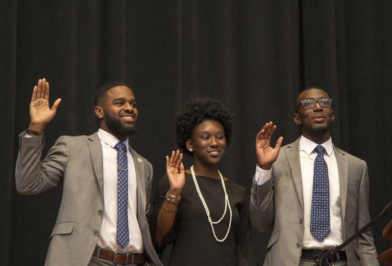 The newly elected administration of the University of Georgia Student Government Association is sworn in during the 31st SGA inauguration at UGA Chapel in Athens, Georgia, on Wednesday, April 4, 2018. The new officials include Treasurer Destin Mizelle, left, Vice President Charlene Marsh, middle, and President Ammishaddai Grand-Jean. (REANN HUBER/REANN.HUBER@AJC.COM)