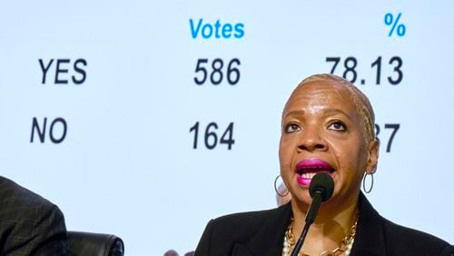 Bishop Tracy Smith Malone surveys the results of a delegate vote in favor of a worldwide regionalization plan as she presides over a legislative session of the 2024 United Methodist General Conference in Charlotte.The proposal needed a two-third majority vote to pass. (Paul Jeffrey/UM News via AP)