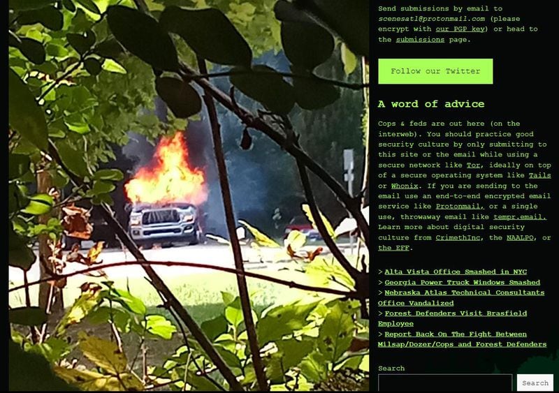 A screenshot of a post on "Scenes from the Atlanta Forest," a blog with contributions by far left activists trying to stop the construction of Atlanta's new public safety training center. The image shows a tow truck purportedly set ablaze by activists.