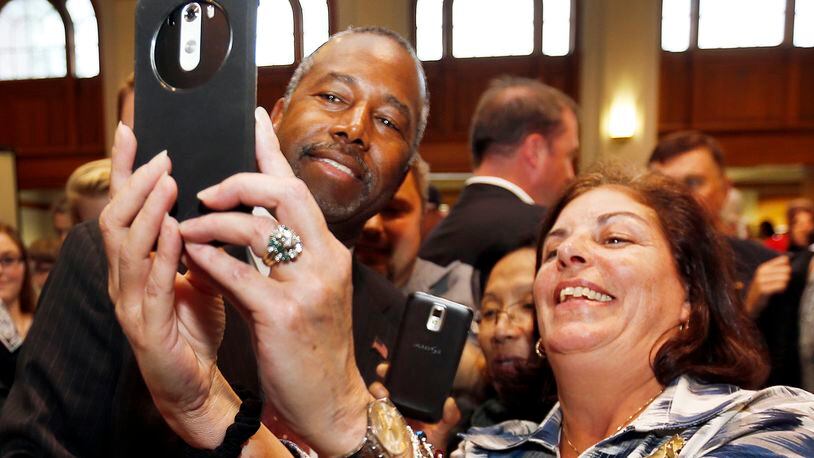 Republican presidential candidate and retired neurosurgeon Ben Carson poses for a photos during a campaign stop at the University of New Hampshire Wednesday, Sept. 30, 2015, in Durham, N.H.