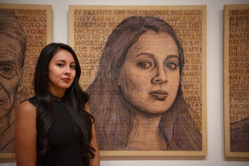 Artist and activist Yehimi Cambrón in front of a self-portrait at the High Museum of Art. Photo courtesy of Kristin Ferro.