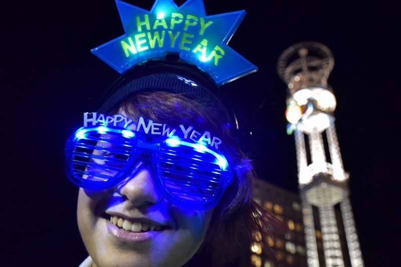 Daesum Butler, of Whitesburg, wears her New Year glasses at Underground Atlanta during Peach Drop 2015. The largest New Year’s Eve celebration in the southeast, this gathering of more than 100,000 revelers is set to move to a new location. HYOSUB SHIN / HSHIN@AJC.COM