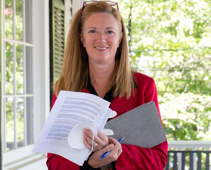 Attorney Dawn Levine continues to do business from the front porch of her office and online for those creating or updating their wills. An executive order by Gov. Brian Kemp is allowing temporary online options for signatures.Jenni Girtman for The Atlanta Journal-Constitution