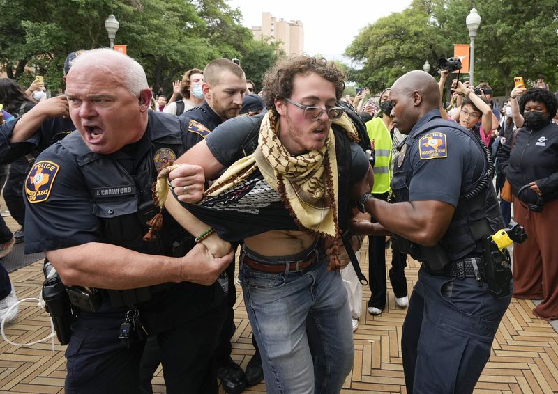 University of Texas police officers arrest a man at a pro-Palestinian protest on campus, Wednesday April 24, 2024, in Austin, Texas. (Jay Janner/Austin American-Statesman via AP)