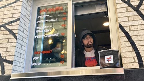 Eminem works the window of Mom's Spaghetti in Detroit on Wednesday.