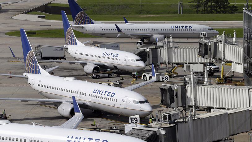 FILE - In this July 8, 2015, file photo, United Airlines planes are parked at their gates as another plane, top, taxis past them at George Bush Intercontinental Airport in Houston. United Airlines says it will raise the limit to $10,000 on payments to customers who give up seats on oversold flights and will increase training for employees as it deals with fallout from the video of a passenger being violently dragged from his seat. (AP Photo/David J. Phillip, File)