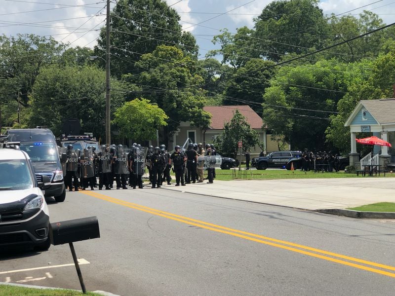 Saturday, Aug. 15, 2020, Stone Mountain -- Police officers in riot gear close in on protesters in the city.