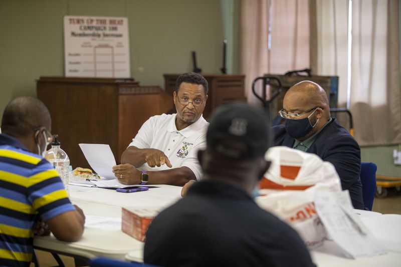 Pastor Hosea Miller Jr., left, of New True Fellowship Baptist Church, speaks during a clergy meeting hosted by Pastor Michael White at Litman Cathedral House of God Saints In Christ in Albany, earlier this month. The pastors and clergy men have been meeting to discuss how to combat the gun violence in their neighborhoods. (Alyssa Pointer/Atlanta Journal Constitution)