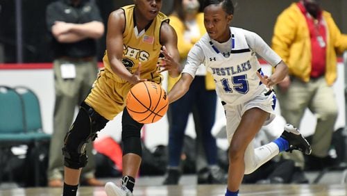 Westlake's Cynthia Walton (15) steals a ball from Carrollton's Kehinde Obasuyi (2) during Friday's 6A girls state title game in Macon.