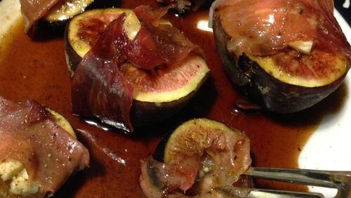 Create a ‘well’ in the middle of the fig halves with your finger and fill them with blue cheese. Then wrap proscuitto around the fig halves. While they’re baking, make a simple sauce with balsamic vinegar, honey and pepper. Your dinner guests will swoon over the result. (Staff photo by Connie Post)