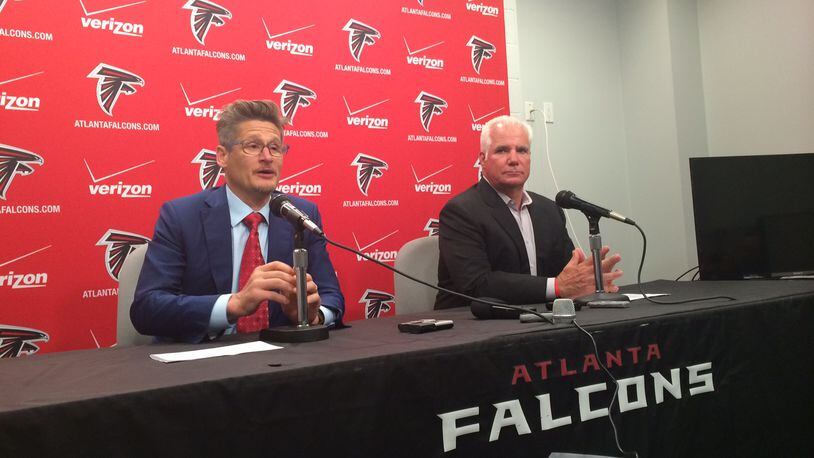 Falcons general manager Thomas Dimitroff and head coach Mike Smith discussing the second and third round picks in May during the draft. (D. Orlando Ledbetter/Dledbetter@ajc.com)