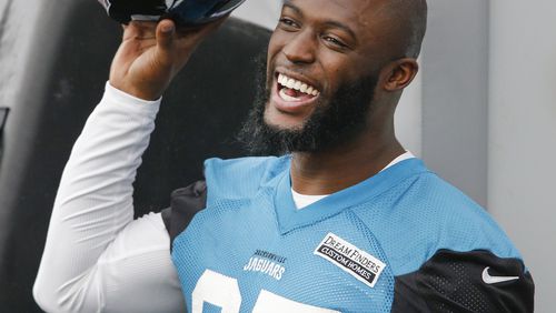 Jacksonville Jaguars running back Leonard Fournette (27) has a laugh on the sidelines during organized team activities at TIAA Bank Field.