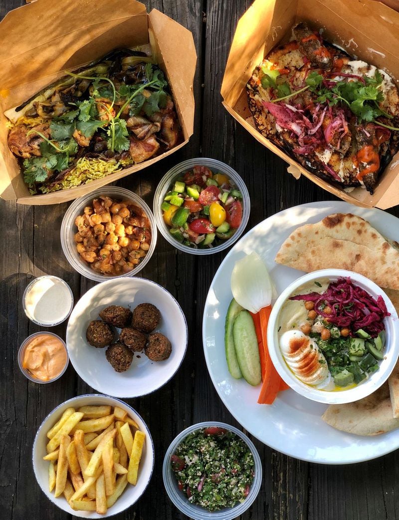 This takeout spread from Rina includes chicken amba, beef kebabs, hummus and pita, tabbouleh, fries, falafel, chickpea and date salad, and Israeli salad. CONTRIBUTED BY WENDELL BROCK
