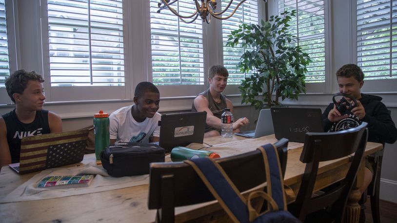 Howard Middle School eighth graders Jude Paulson (from left) Jahson Jahi (second for left), Jack Jenkins (second from right) and Dean Paulson (right) interact with each other on Friday, August 28, 2020. (Alyssa Pointer / Alyssa.Pointer@ajc.com)