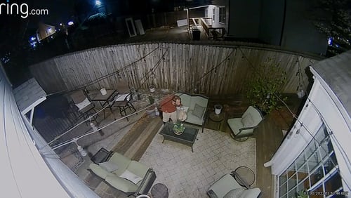 A suspected burglar prowls through the backyard of a home in northeast Atlanta near Buckhead on March 30.