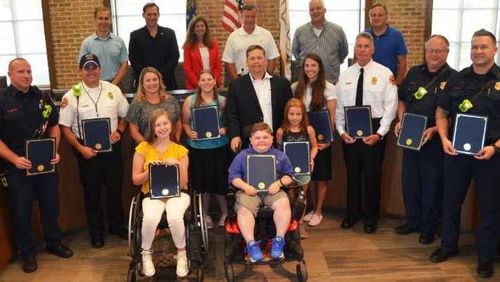 Milton City Council (top row) with members of the Milton Fire-Rescue Department, and MDA representatives and local MDA families.