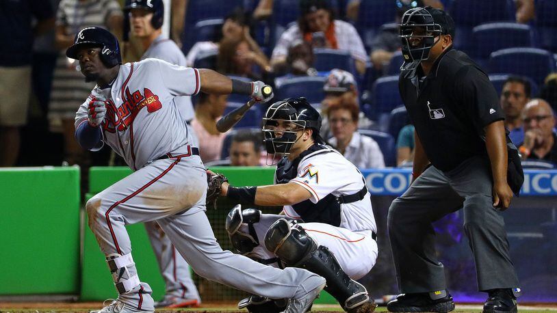 Adonis Garcia #13 of the Atlanta Braves hits a two-RBI single in the eighth inning during a game against the Miami Marlins at Marlins Park on April 15, 2016 in Miami, Florida. (Photo by Mike Ehrmann/Getty Images)