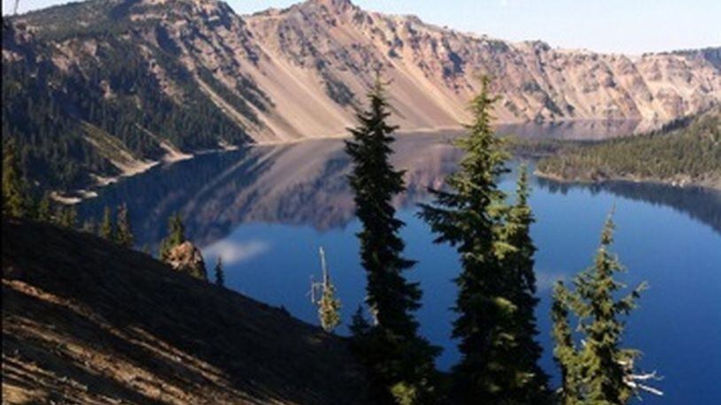 While visiting a friend in Oregon, Judy Cleveland took this photo of Crater Lake. “We took a drive out to southern Oregon so she could show me this beautiful wonder of the world!” she wrote. “I was in awe of its beauty and pretty darn proud of my camera phone pic.” Crater Lake is in the Cascade Mountains of southern Oregon. It was formed by the now-collapsed volcano, Mount Mazama. Wizard Island is a cinder cone near the western edge of the lake. The Rim Drive, a road surrounding the lake, offers views of the national park’s volcanic formations. The park’s numerous trails include Sun Notch, with views of the Phantom Ship, a small island.