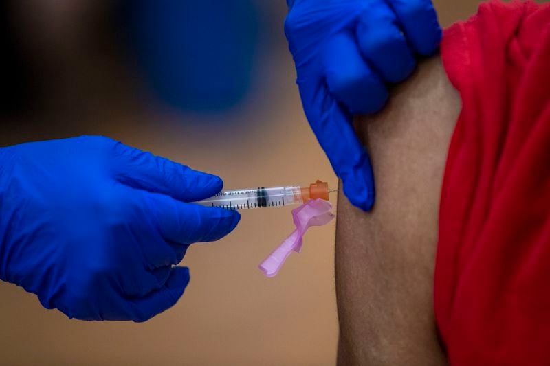 A COVID-19 vaccination is administered during a DeKalb County Board of Health and Delta Sigma Theta Sorority, Inc. COVID-19 vaccination event at the Lou Walker Senior Center in Stonecrest, Wednesday, February 10, 2021. (Alyssa Pointer / Alyssa.Pointer@ajc.com)