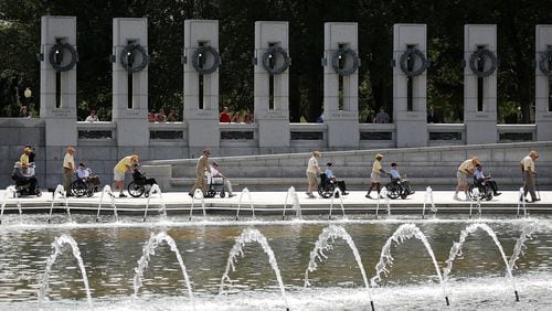 WWII veterans in wheel chairs are escorted during the annual V-J Day Observance to commemorate the Allied Forces victory in the Pacific and the end of World War II, at the World War II Memorial, on September 2, 2016 in Washington, DC.  (Photo by Mark Wilson/Getty Images)