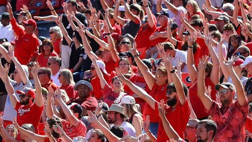 Georgia fans signal it's fourth-quarter time against Kent State during a hard-fought game Saturday, Sept. 24, 2022, in Athens.   “Curtis Compton / Curtis Compton@ajc.com