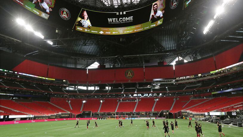 Atlanta United players take the pitch inside a Mercedes-Benz Stadium void of fans to prepare to play Nashville SC on Saturday, Aug. 22, 2020, in Atlanta. (Curtis Compton/Atlanta Journal-Constitution/TNS)