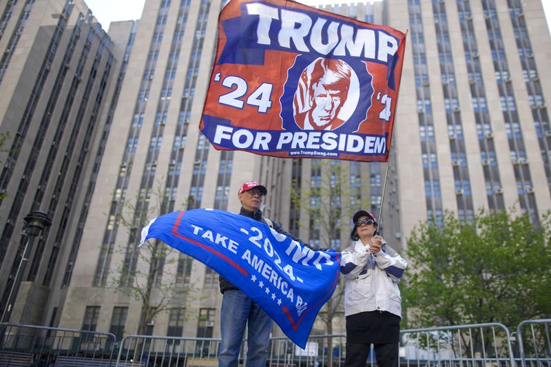 Supporters of former President Donald Trump stand outside Manhattan criminal court building, Monday, April 22, 2024, in New York. Opening statements in Trump's historic hush money trial are set to begin. (AP Photo/Mary Altaffer)