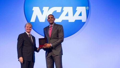 NCAA President Mark Emmert presents Hawks co-owner Grant Hill with the 2017 NCAA President’s Gerald R. Ford Award last month in Nashville.