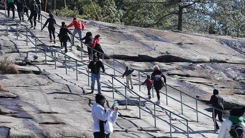 Participants scale a steep section of the trail while commemorating the life of Dr. Martin Luther King, Jr., by climbing to the top of Stone Mountain with children who aspire to be great during "The Dream Walk" on Sunday, Jan. 17, 2016, in Stone Mountain. In his "I Have A Dream" speech, Dr. King spoke of a symbolic bell of freedom ringing from the tops of Stone Mountain to the hills of Tennessee. Curtis Compton / ccompton@ajc.com