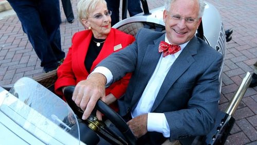 First Lady of Georgia Sandra Deal catches a ride with Roswell Mayor Jere Wood in his 3-wheel Morgan to a campaign stop on Oct. 16, 2014 in Roswell. The Roswell City Council is asking the Legislature to clarify when the three-term limit for the mayor’s office should apply. CURTIS COMPTON / CCOMPTON@AJC.COM