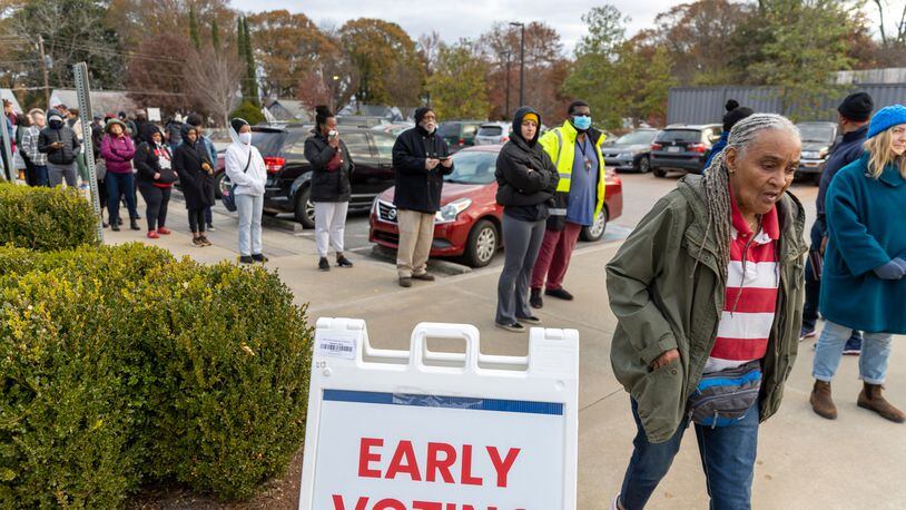 Voters wait in line on the last day of early voting in metro Atlanta for December's U.S. Senate runoff. Some lines lasted more than two hours during early voting for the runoff, caused in part by a compressed runoff period with high turnout. (Arvin Temkar / arvin.temkar@ajc.com)