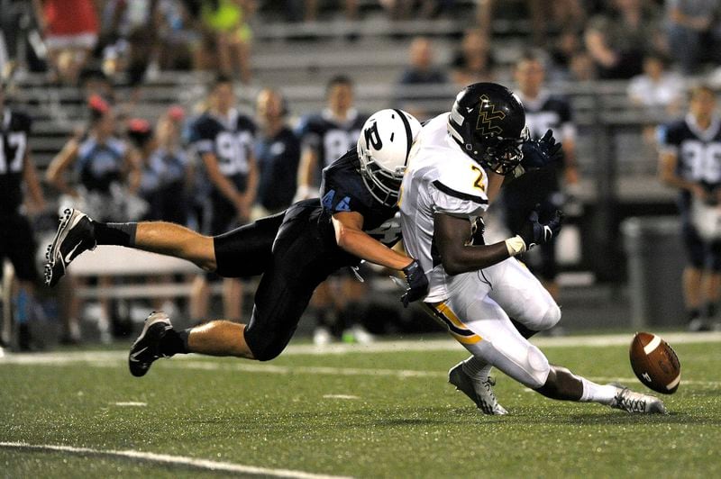 Allen Artis, right, is shown in 2013 during his high school career at Wheeler High in a game against Pope.