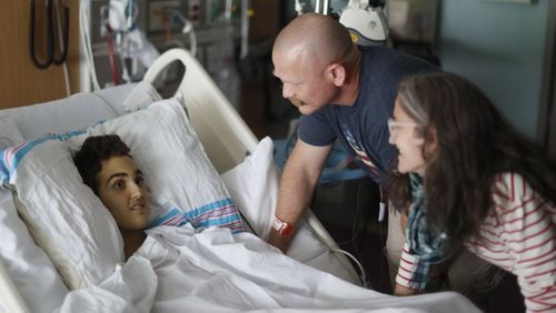 May 30, 2019 - Atlanta - Logan Droke and his father, Randall, and step mother, Veronique, spend some time together in his hospital room. Logan, 18, from Canton, facing his fourth battle with leukemia at Children’s Healthcare of Atlanta at Scottish Rite, is set to graduate from Creekview High School on Friday. Firefighters in two departments are rallying behind the teenager by raising money to help pay for treatments. Bob Andres / bandres@ajc.com